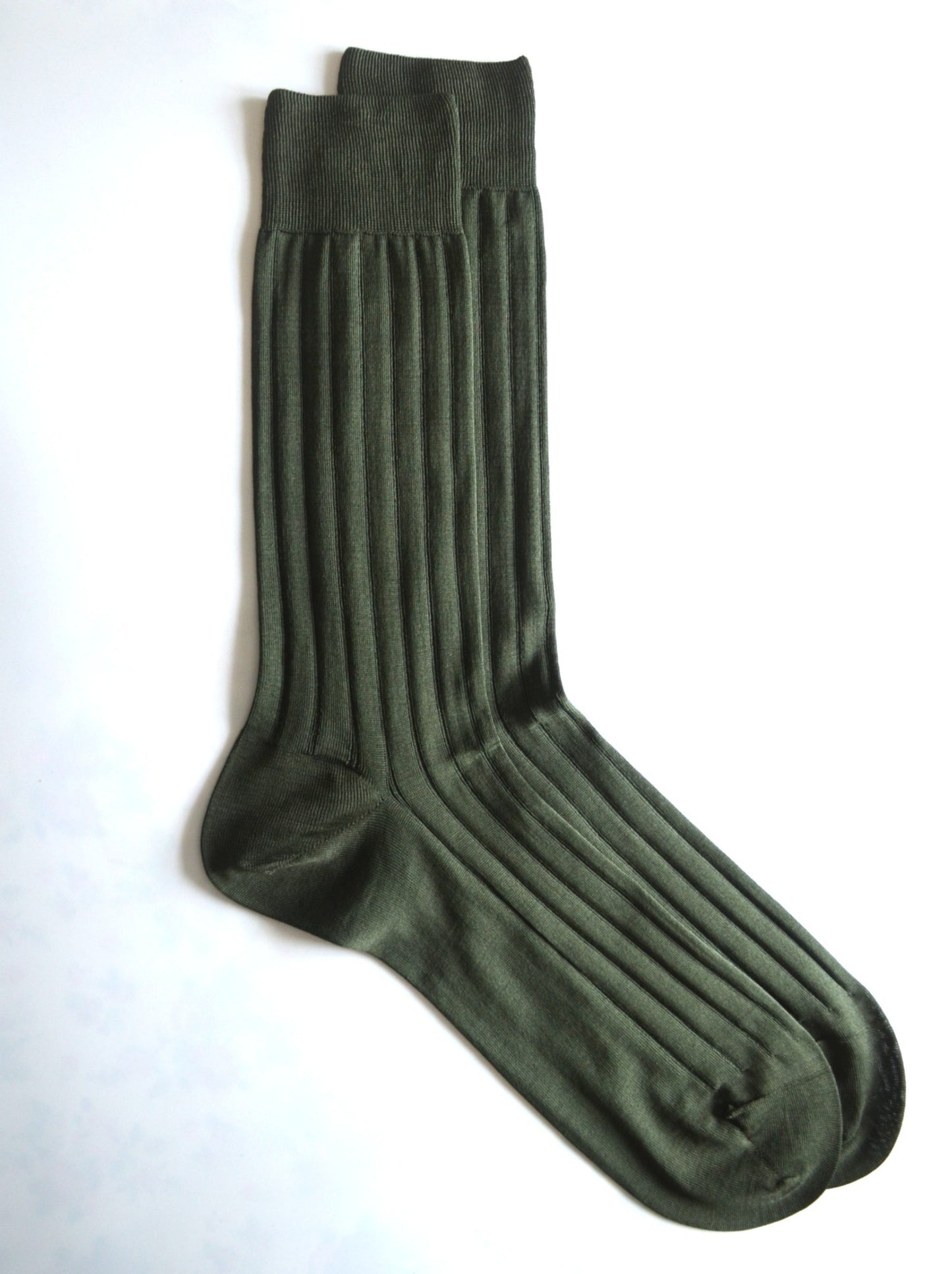 Pair of green socks on a white background